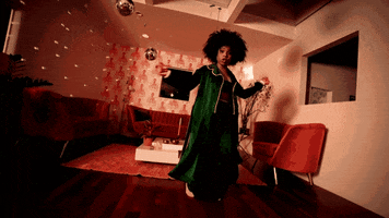 woman dances enthusiastically at home